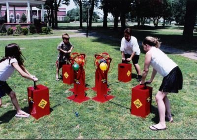 picture of people playing game where they have to pump a balloon with air.