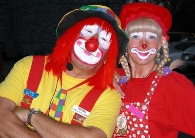 Image of two people dressed up as clowns