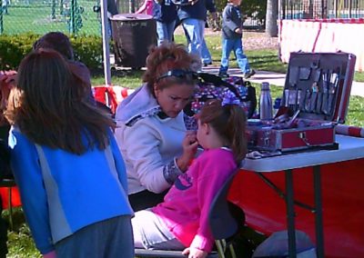 Picture of woman applying face paint to a child