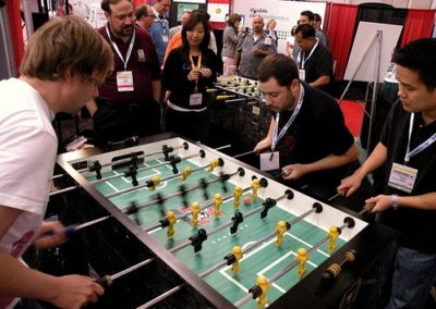 picture of adult men playing a game on a foosball table