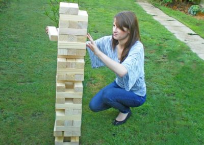 Picture of woman playing giant jenga