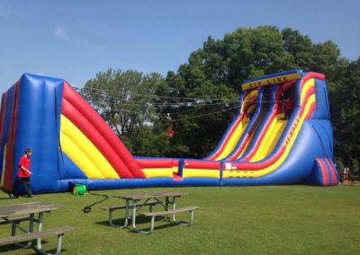 What is 70 feet long and 30 feet high and goes 22 MPH? Our fun, new Zip-Line! It's sure to be a hit at your next event.